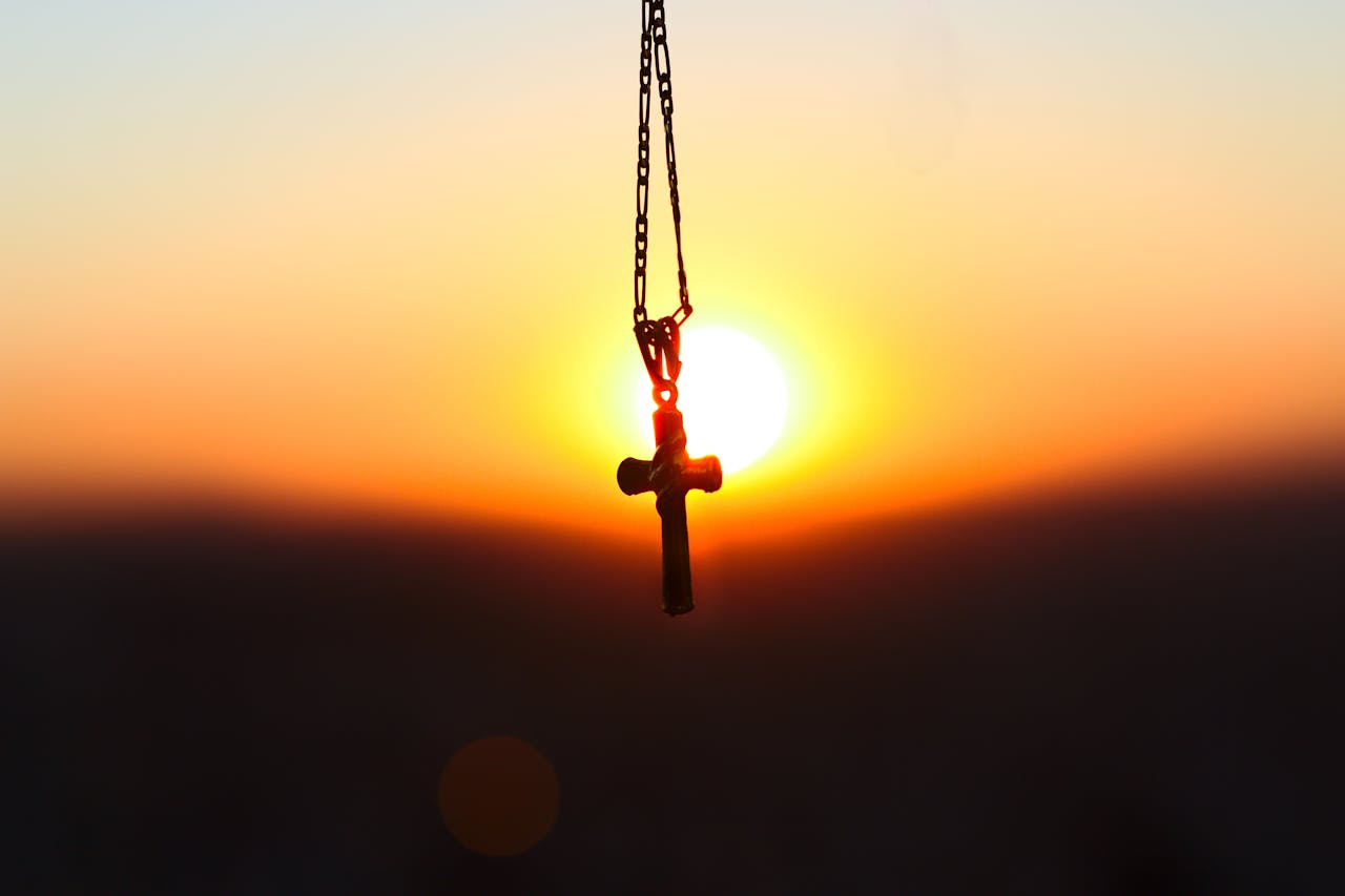 Church cross at sunset